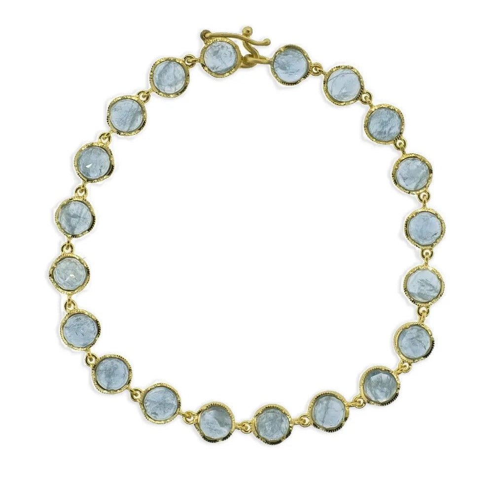 Gold bezel set light blue sapphire bracelet