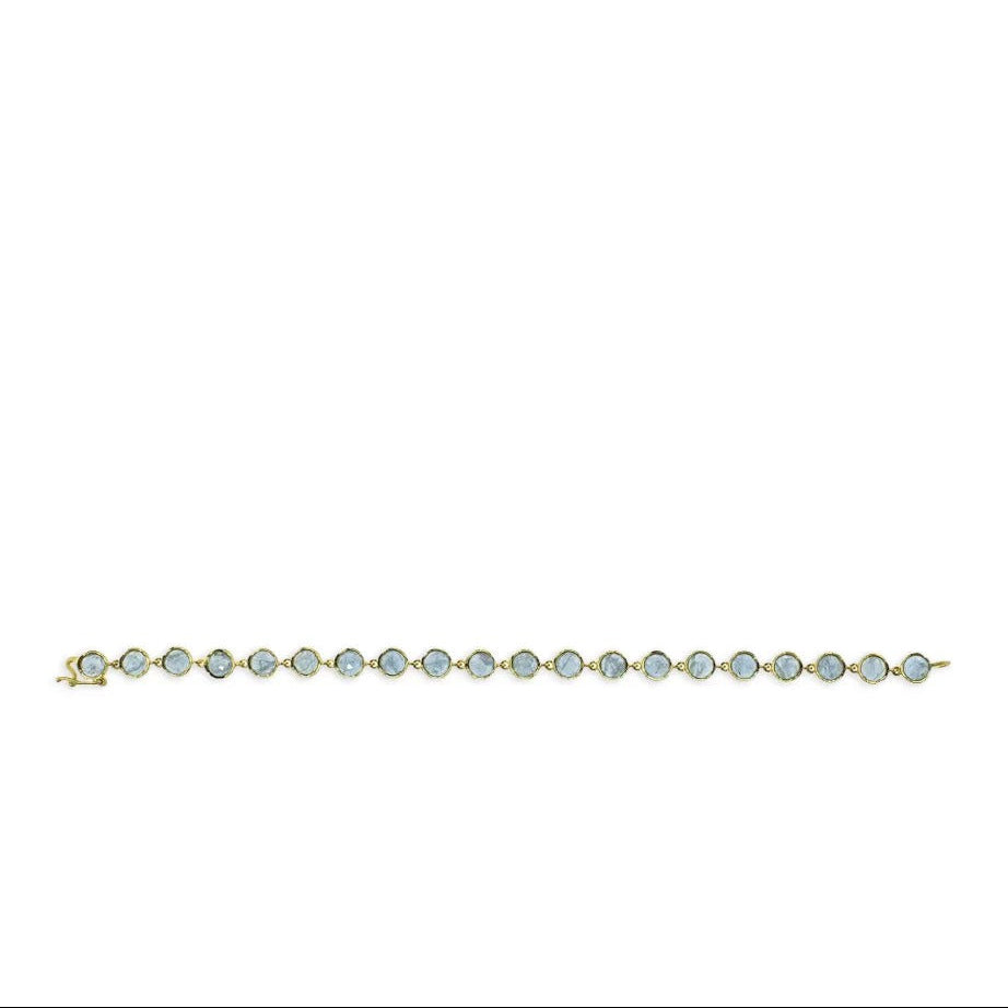 Gold bezel set light blue sapphire bracelet